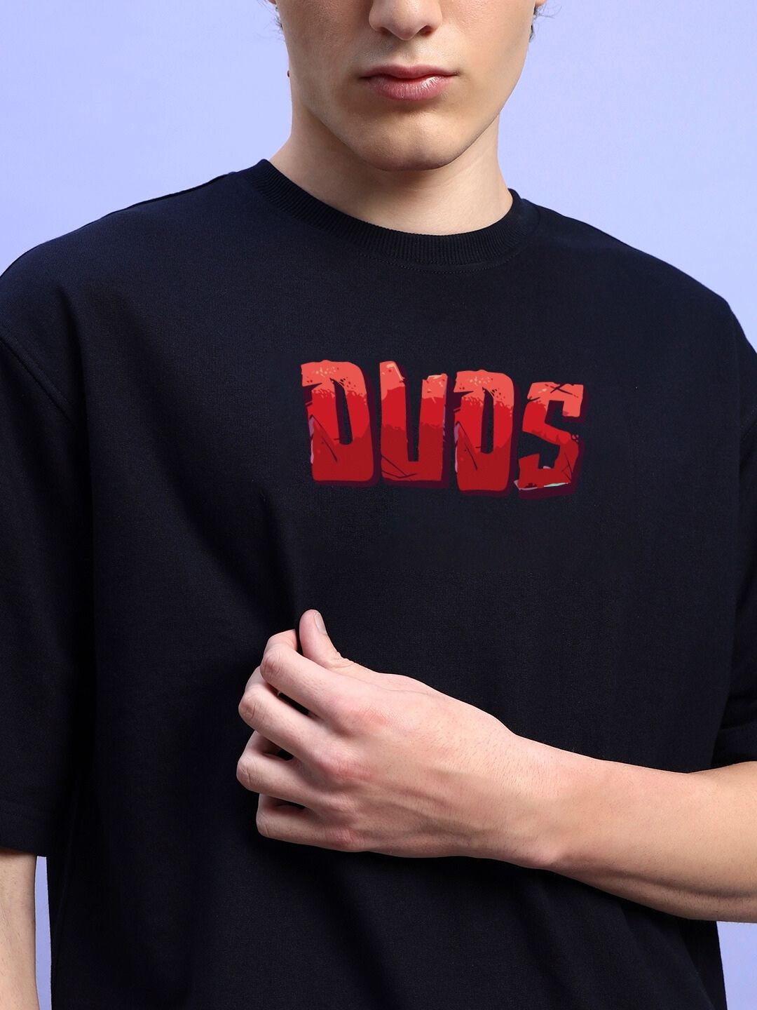 Person wearing AMPERES PRINT OVERSIZED T-SHIRT BLACK with bold red text design.