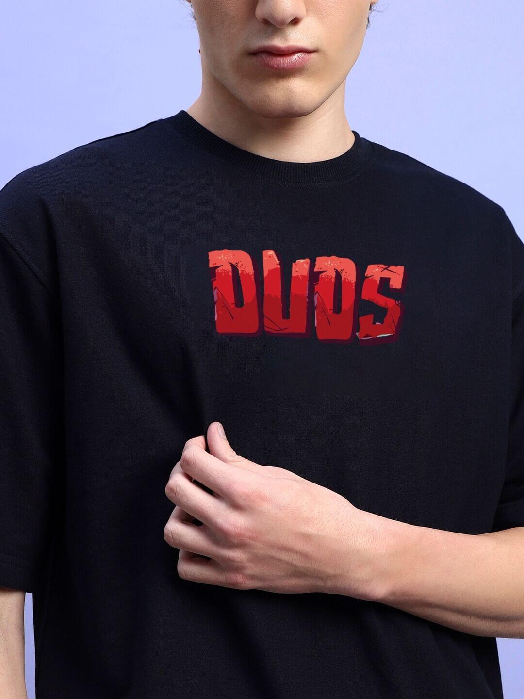 Person wearing AMPERES PRINT OVERSIZED T-SHIRT BLACK with bold red print on black fabric.