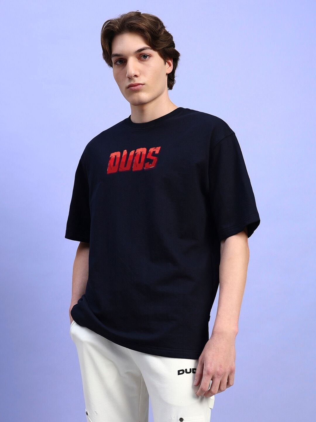 AMPERES PRINT OVERSIZED T-SHIRT BLACK worn by a model, showcasing the design and fit on a light purple background.