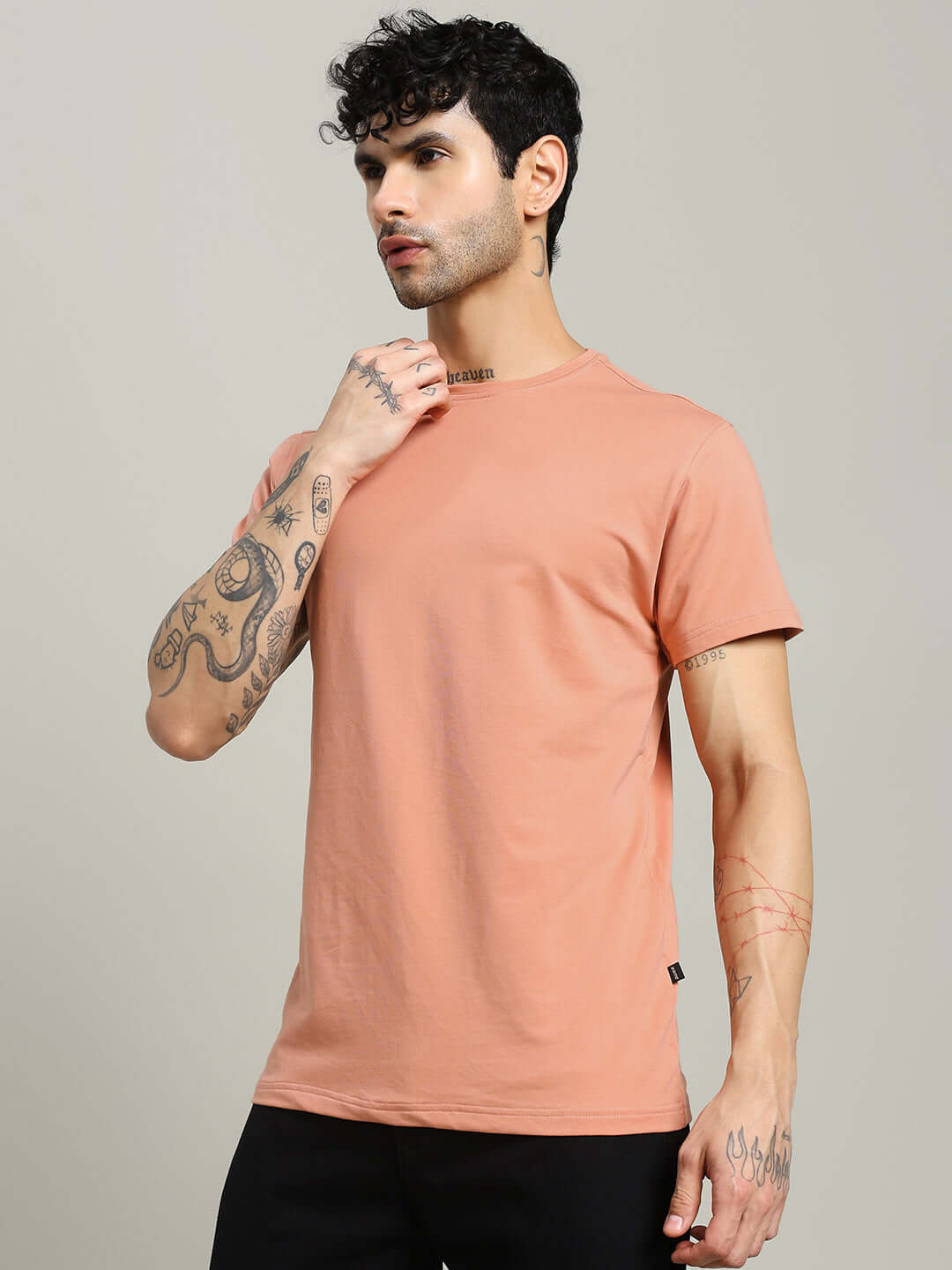 Model wearing Andrew Regular Fit T-shirt in peach, made of 100% cotton premium fabric, ideal for casual wear, by Color By Colours.