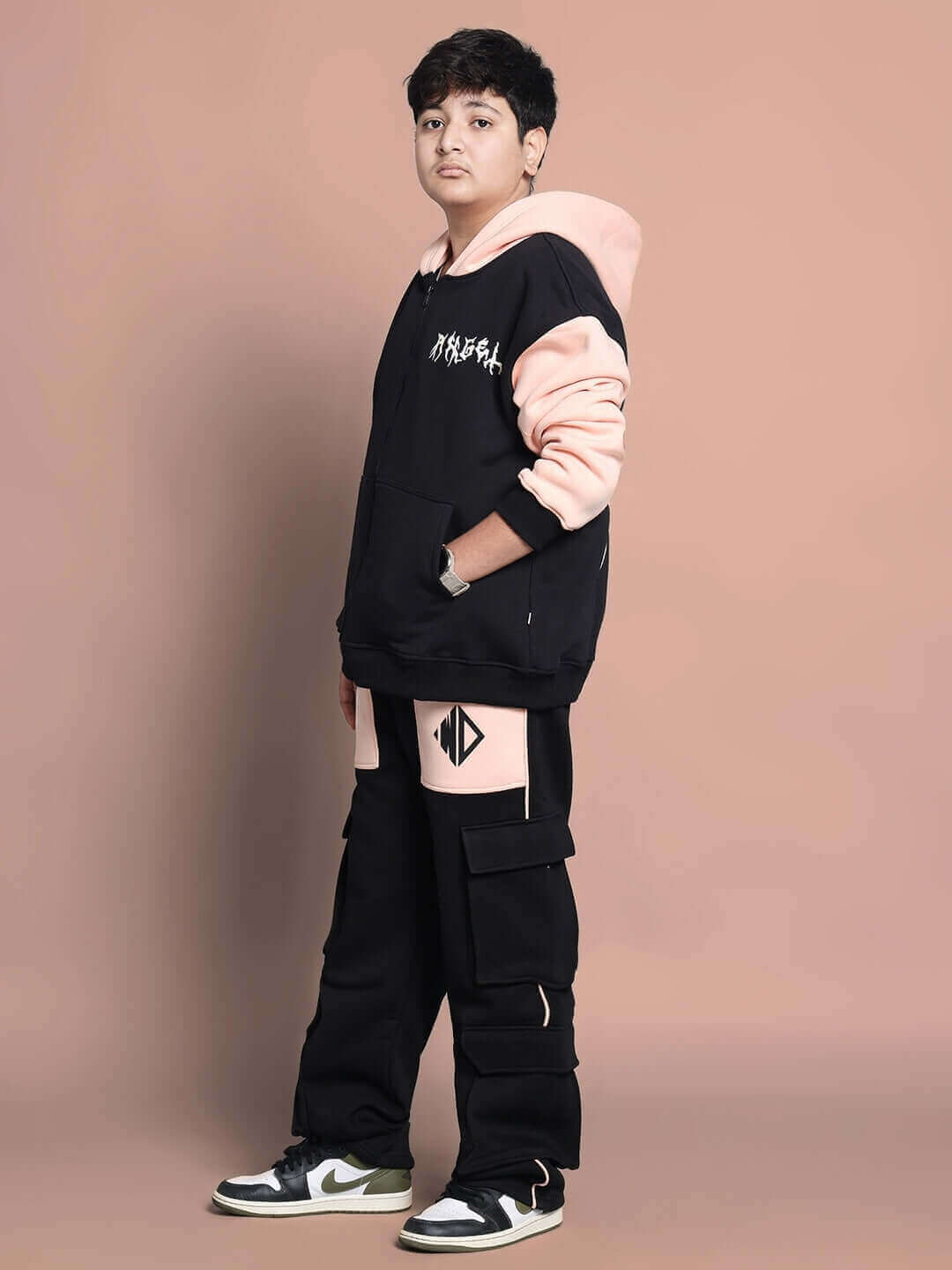 Child wearing ANGEL WINGS Fleece Jogger in black-beige, showcasing streetwear style and comfort from WEAR DUDS.