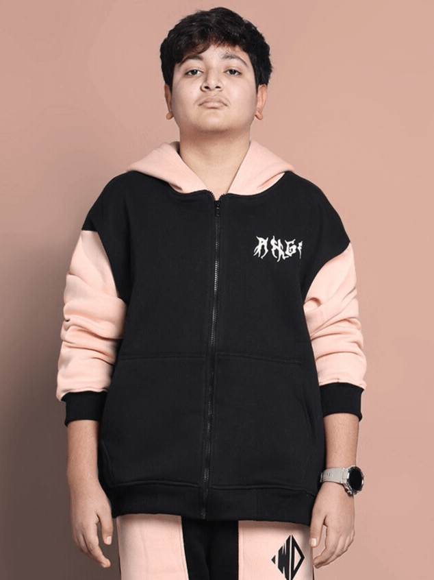 Boy wearing black and beige oversized hoodie with angel wings design