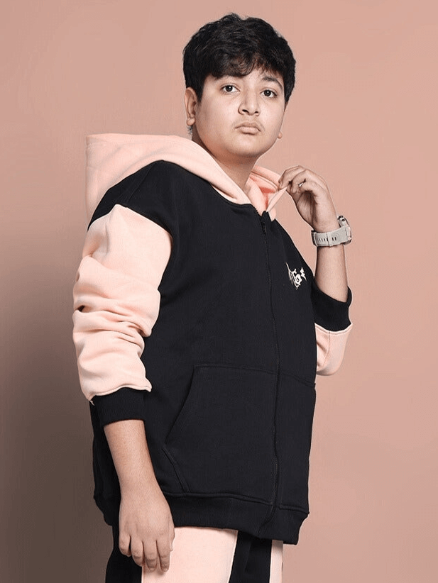 Boy wearing an oversized black-beige hoodie with angel wings design, perfect for boys and girls.