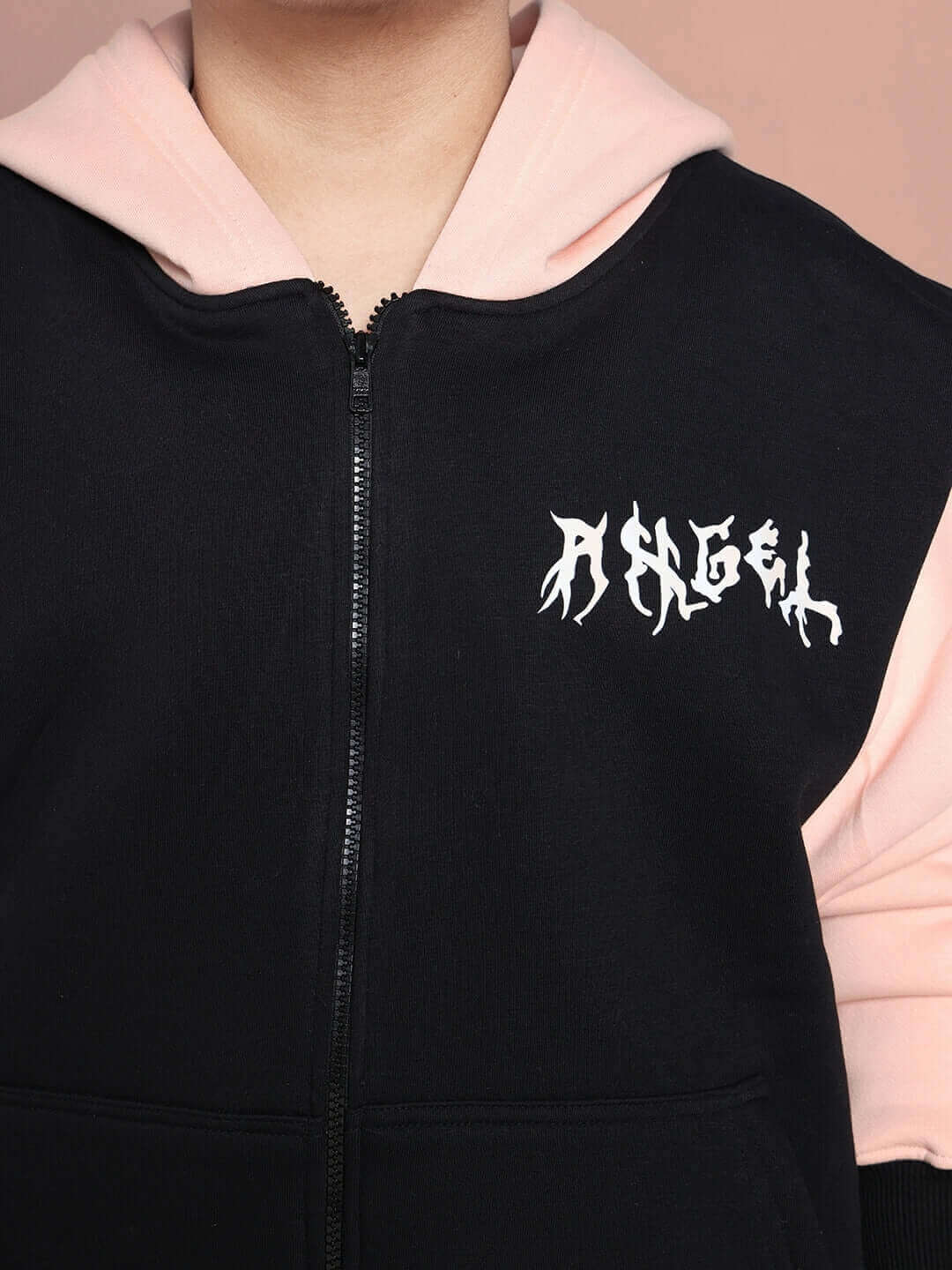 Close-up of black-beige oversized hoodie with 'Angel' text, suitable for boys and girls, featuring unique pink lining design.