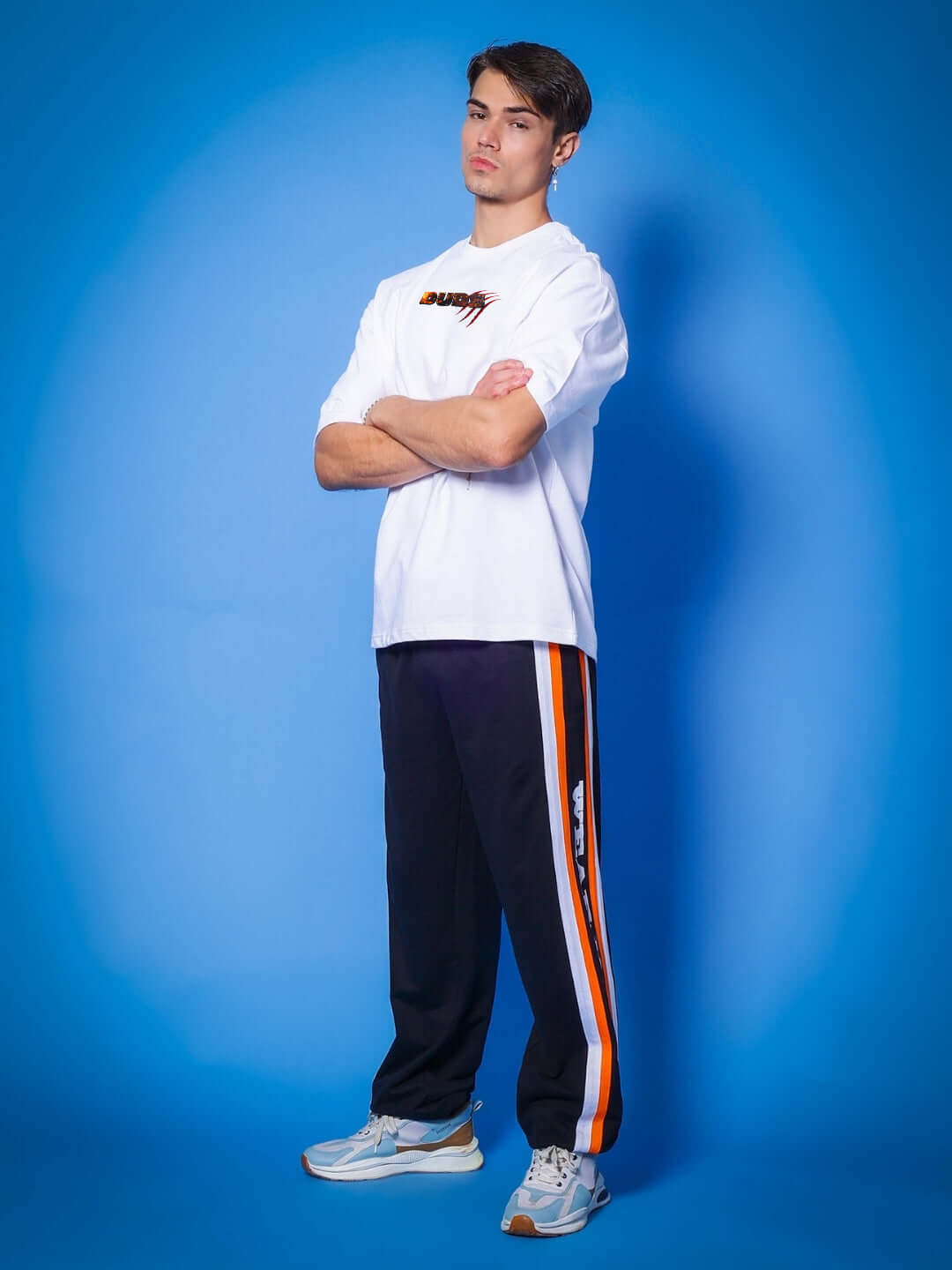 Model wearing ANGRY PANTHER OVERSIZED T-SHIRT WHITE with bold panther graphic in stylish look against a blue background