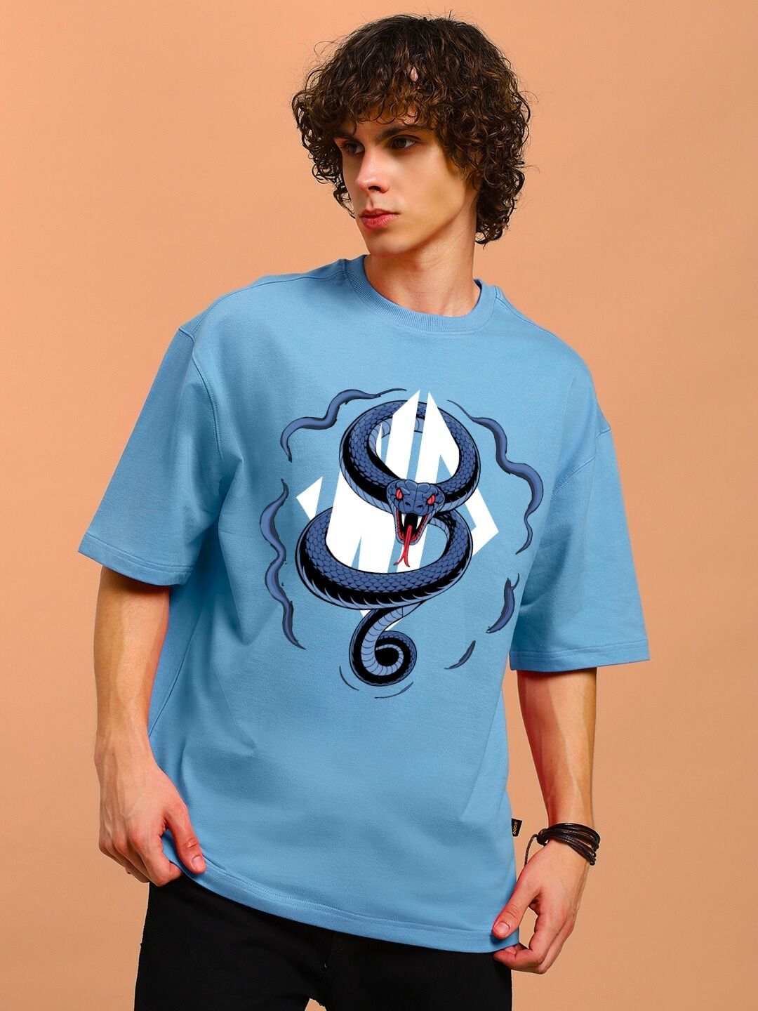 Man wearing ANGRY SNAKE WD PRINTED OVERSIZED T-SHIRT LIGHT BLUE with graphic design on front, casual style