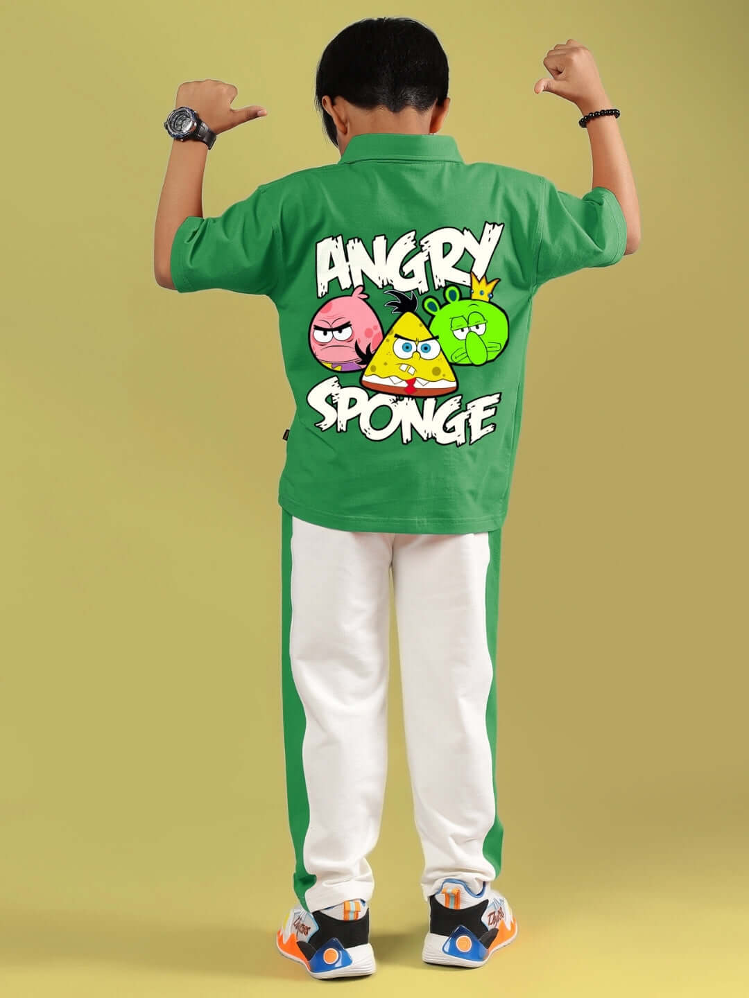 Boy wearing ANGRY SPONGE CO-ORD FOR BOYS & GIRLS GREEN-OFF-WHITE featuring colorful cartoon graphics on back