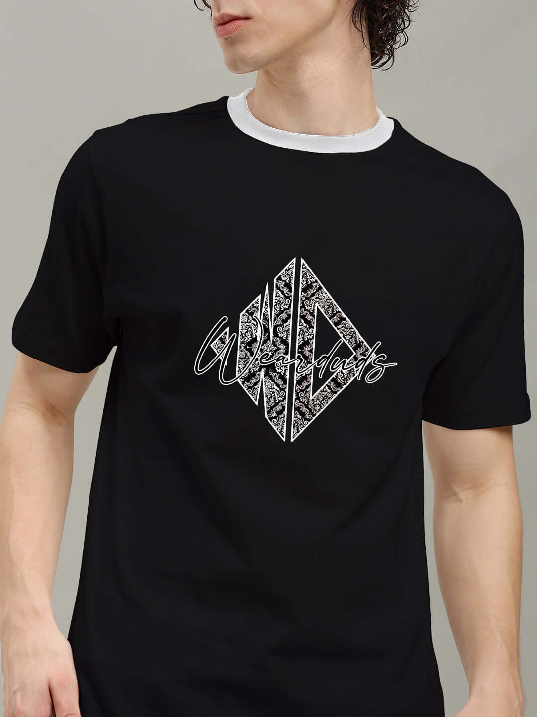 Man wearing ANGULAR REGULAR FIT T-SHIRT BLACK with unique angular graphic print, soft breathable fabric, casual style.