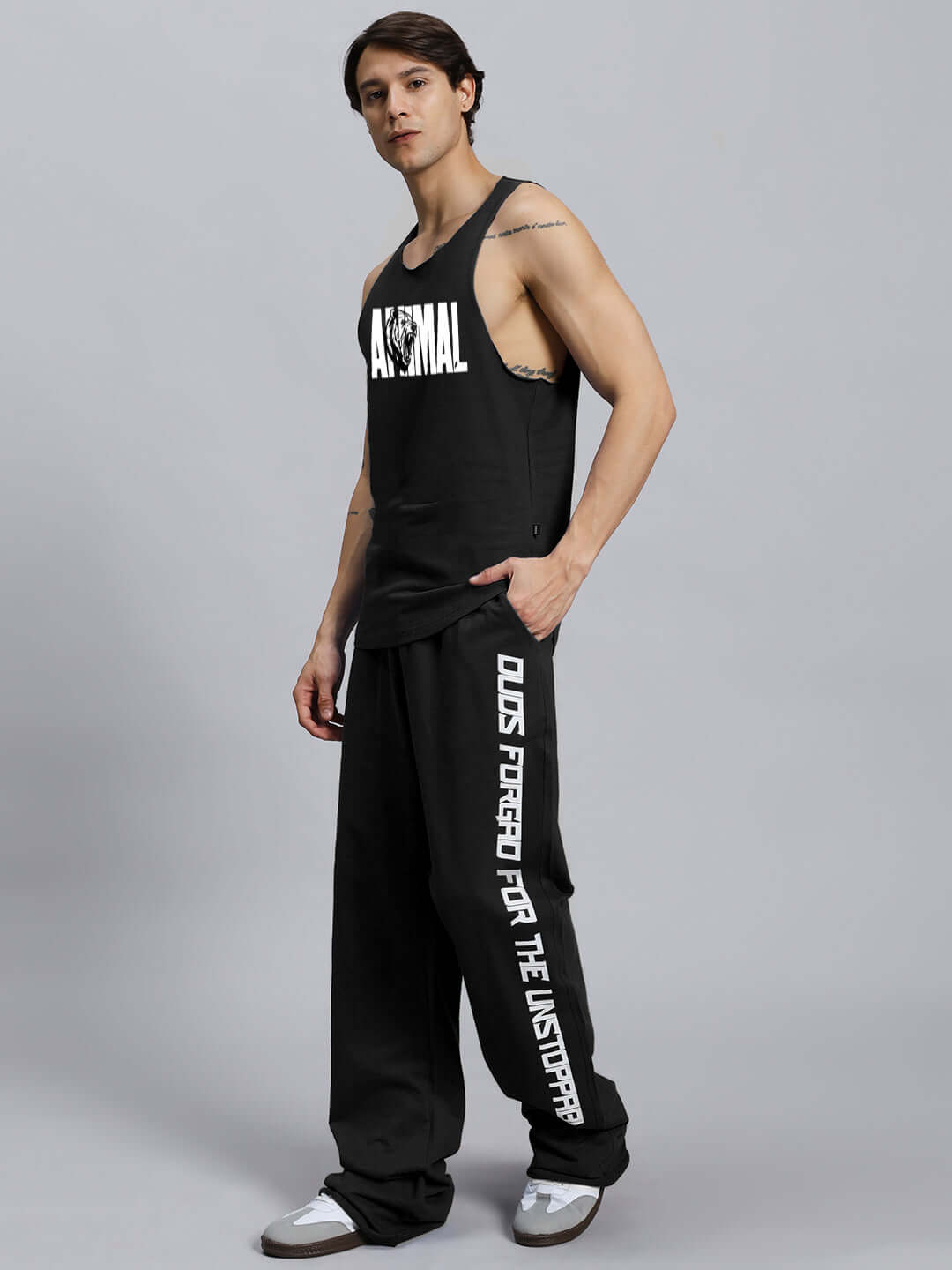 Model wearing ANIMAL PRINTED RELAXED FIT CO-ORD SET BLACK, featuring unisex joggers and tank with customizable waistband.