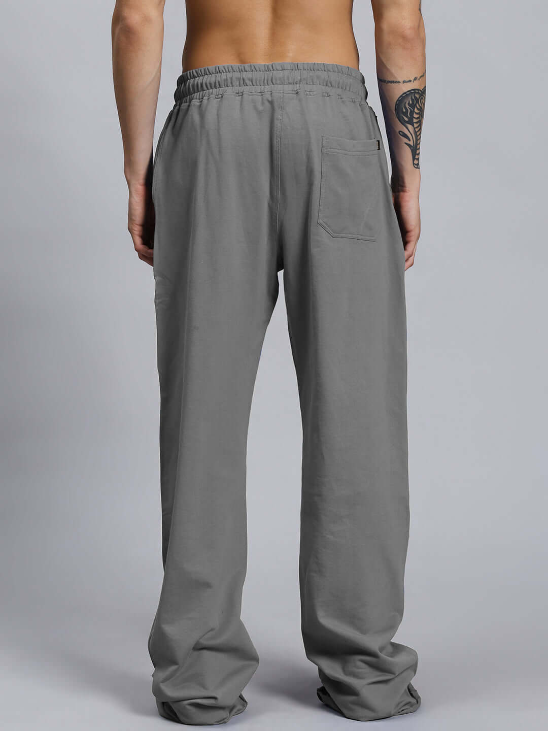 Back view of grey joggers from ANIMAL PRINTED RELAXED FIT CO-ORD SET GREY, unisex with elastic waistband.