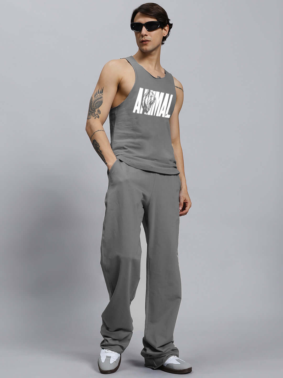 Model wearing ANIMAL PRINTED RELAXED FIT CO-ORD SET GREY, showcasing unisex joggers and tank top with elasticated waistband.
