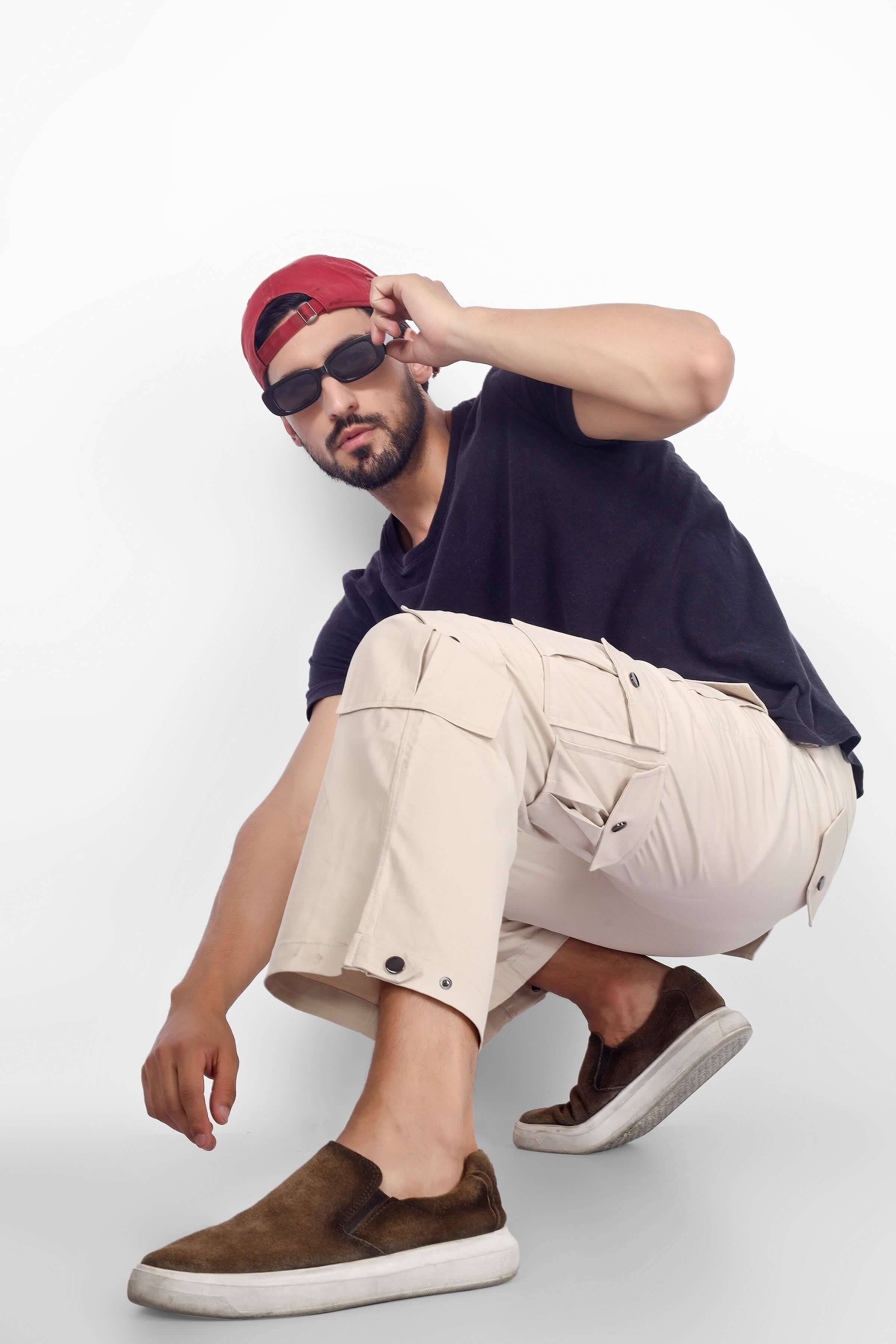 Model wearing Arcadia White 14 Pocket Cargo Pants with casual top and shoes, showcasing style and utility.
