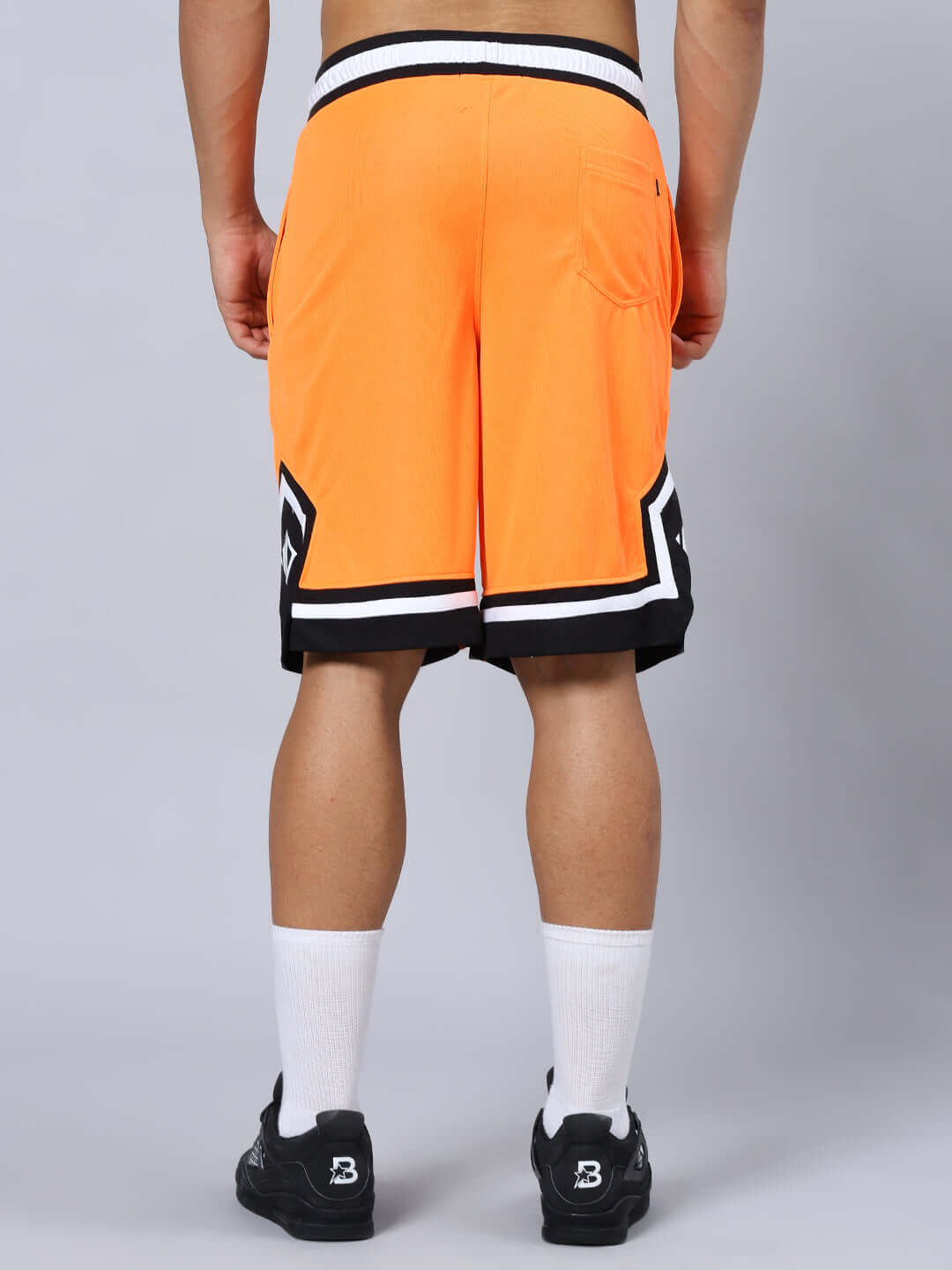 ARMADO REGULAR FIT SHORTS ORANGE BLACK Back view of Armado Regular Fit Orange Black Shorts featuring custom fit option, shown on model. Ideal for active and casual wear.