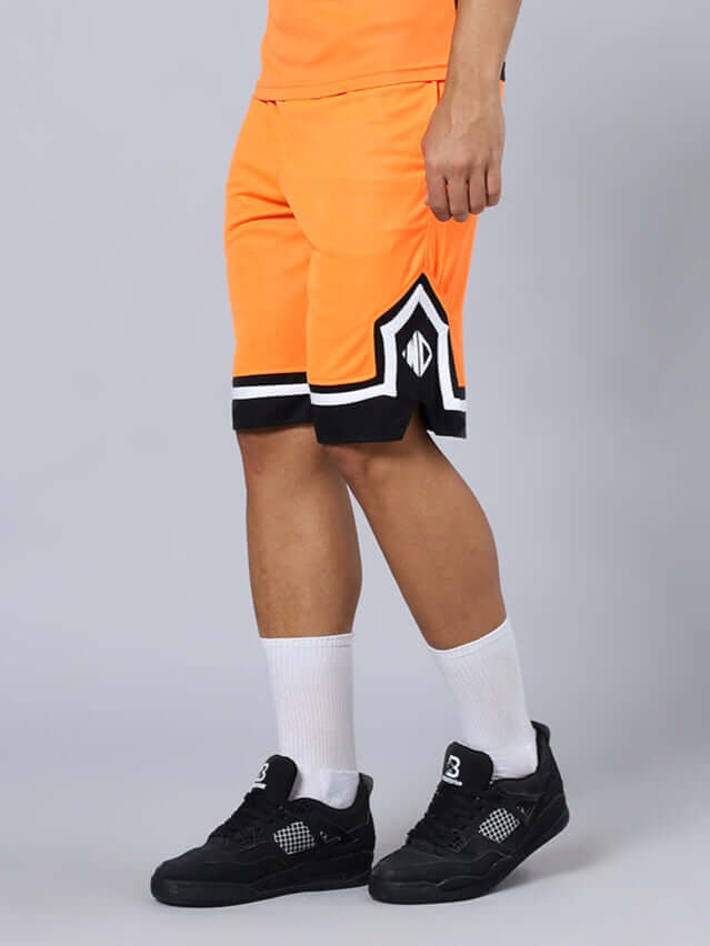 ARMADO REGULAR FIT SHORTS ORANGE BLACK Man wearing ARMADO regular fit orange black shorts with custom fit option, paired with white socks and black sneakers.