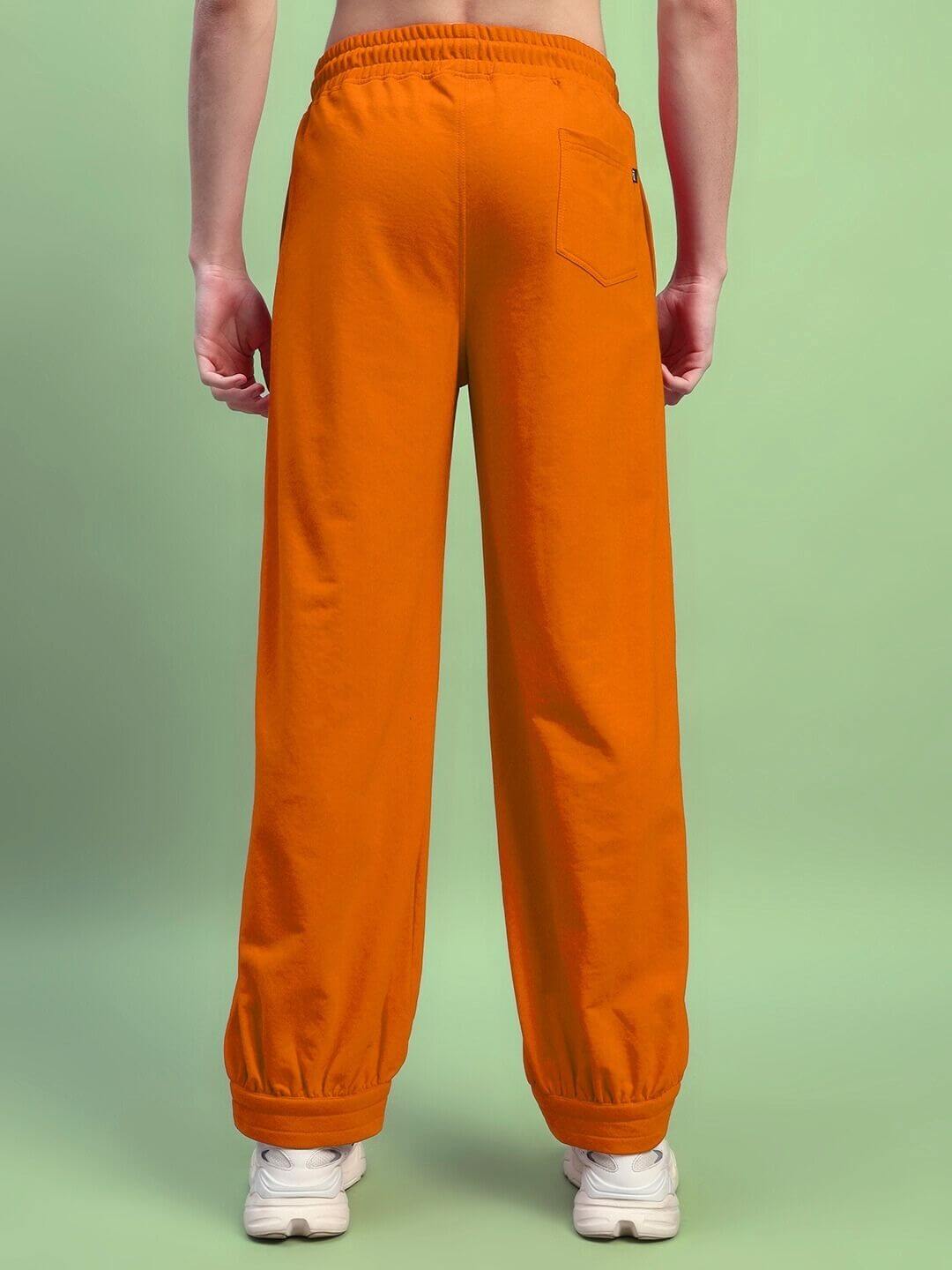 Back view of AUSTRIAN RELAXED-FIT JOGGERS ORANGE with elastic waistband on model