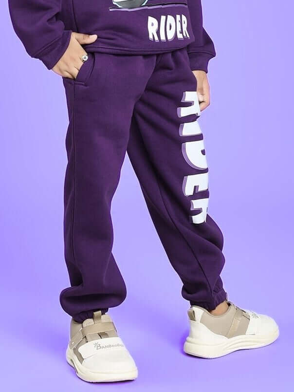AUTHENTIC RIDER FLEECE JOGGER FOR BOYS AND GIRLS PURPLE displayed on child in purple outfit.