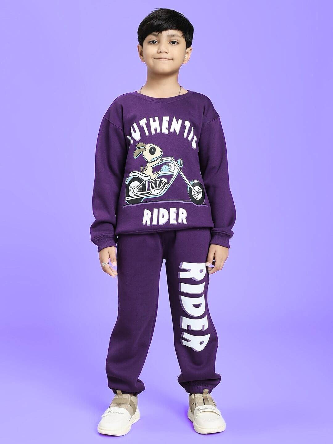 Child wearing AUTHENTIC RIDER FLEECE CO-ORD FOR BOYS AND GIRLS PURPLE with graphic print.