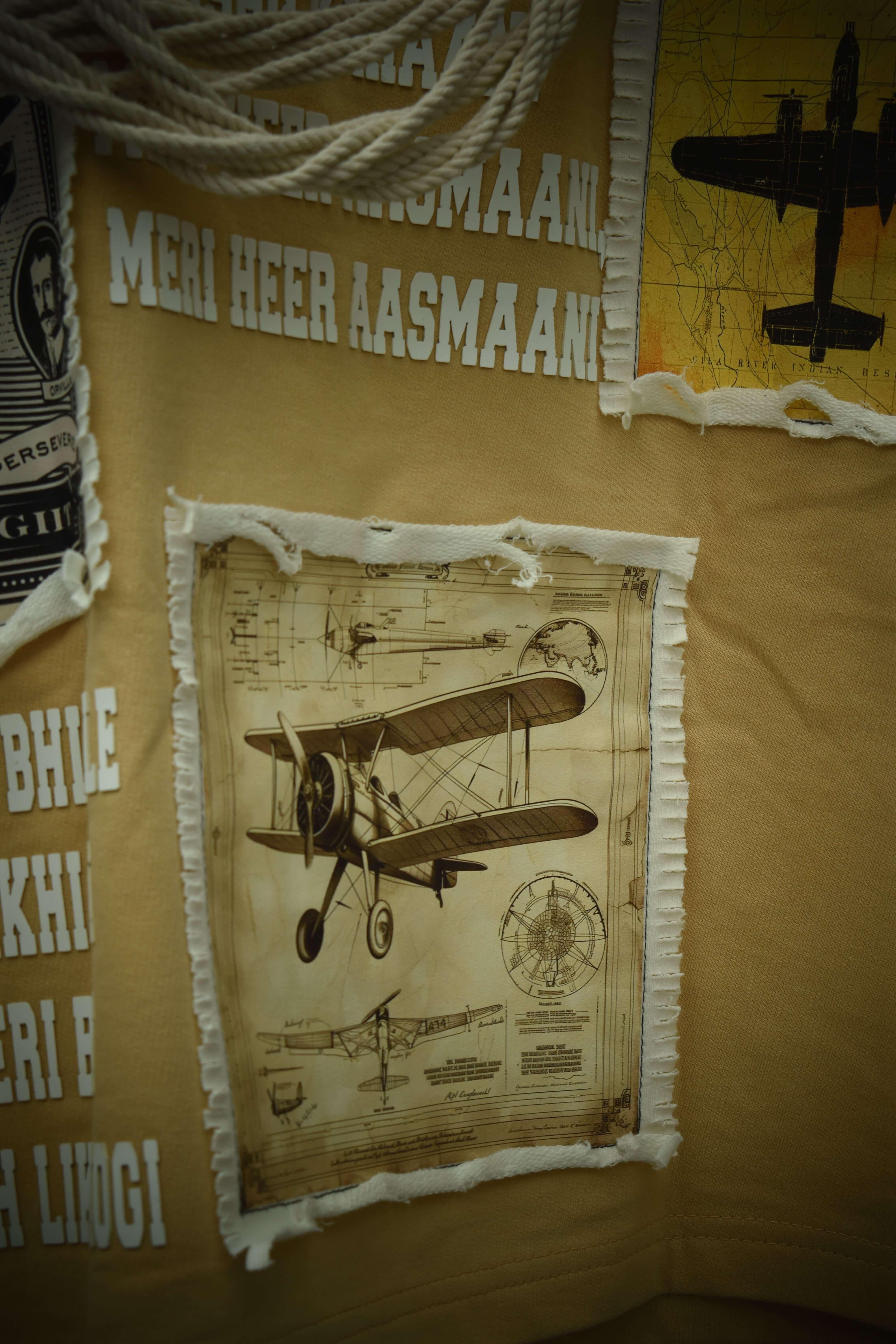 Vintage airplane design on an oversized beige t-shirt with typography, made from premium cotton and elastane, highlighting aviator theme.