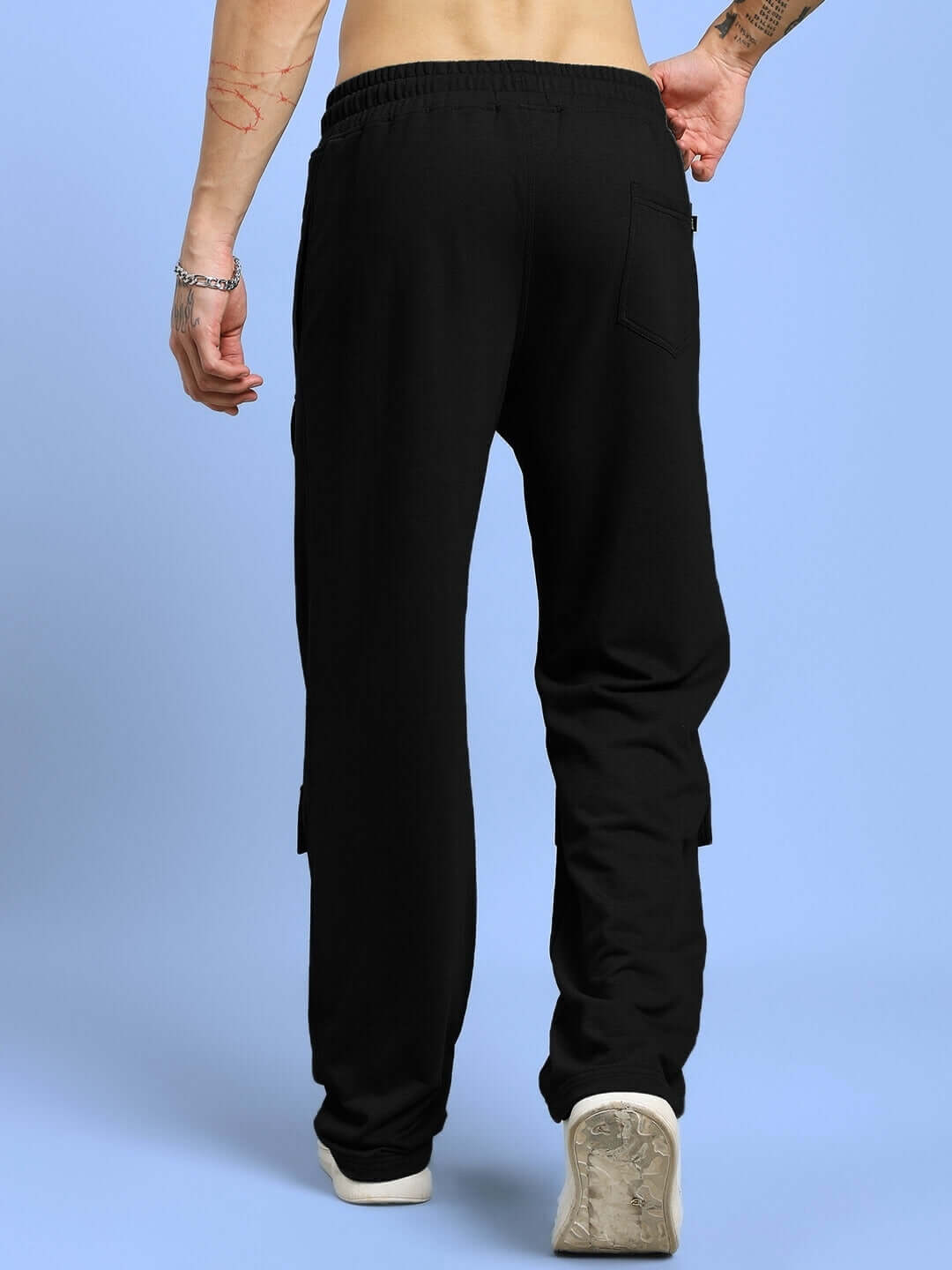 Model wearing AWESOME FLAP POCKET BAGGY JOGGER BLACK showcasing back flap pocket design and relaxed fit.