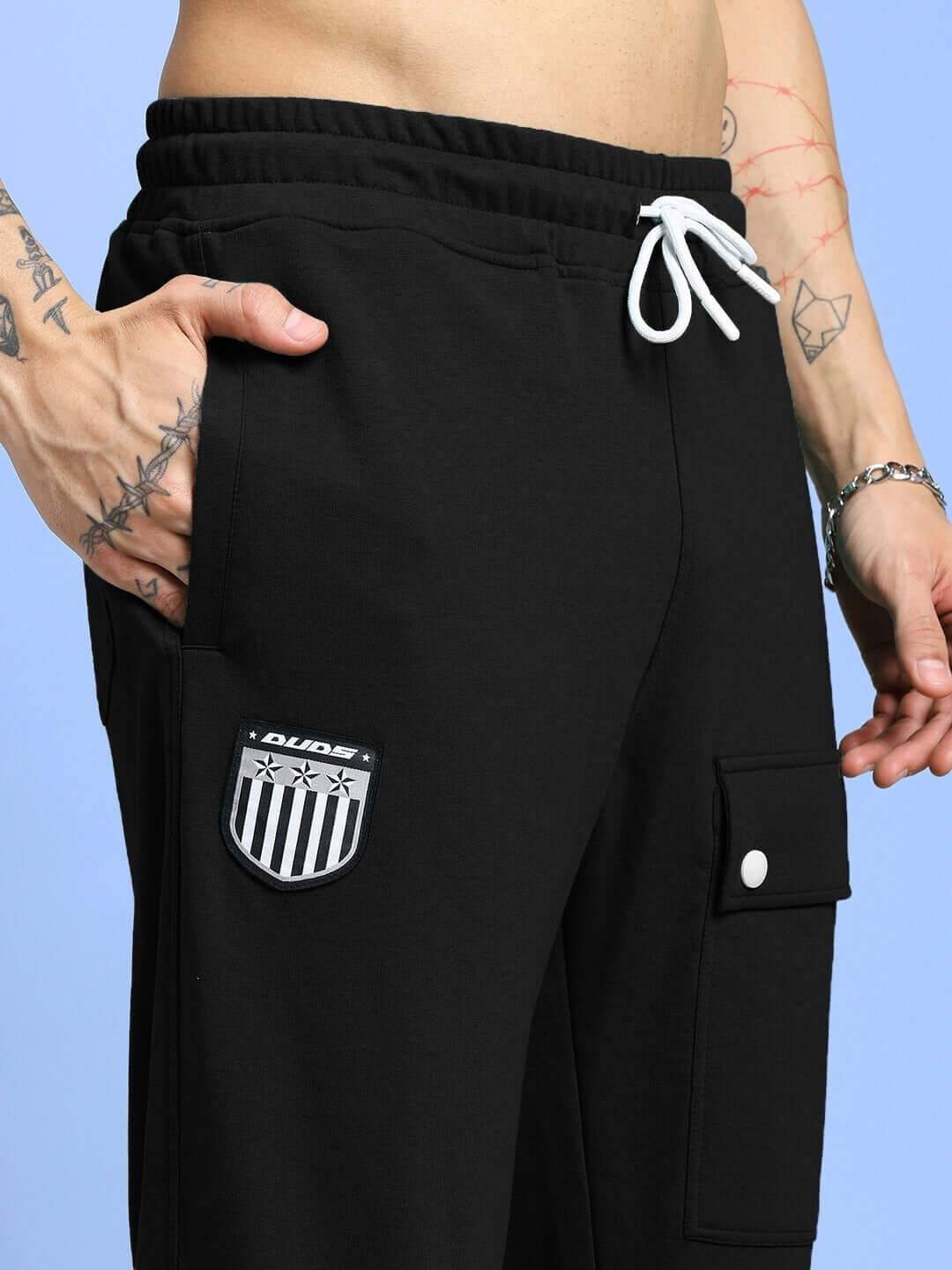 Model wearing AWESOME FLAP POCKET BAGGY JOGGER BLACK with streetwear style, featuring oversized fit and utilitarian flap pockets.