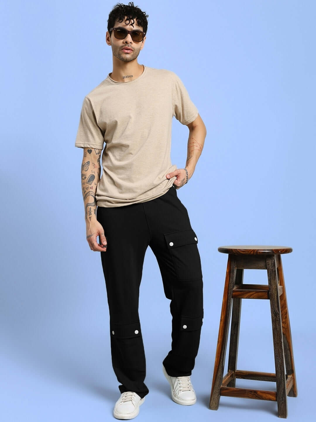 AWESOME FLAP POCKET BAGGY JOGGER BLACK styled on a model with a beige shirt, featuring bold streetwear appeal and versatile utility.