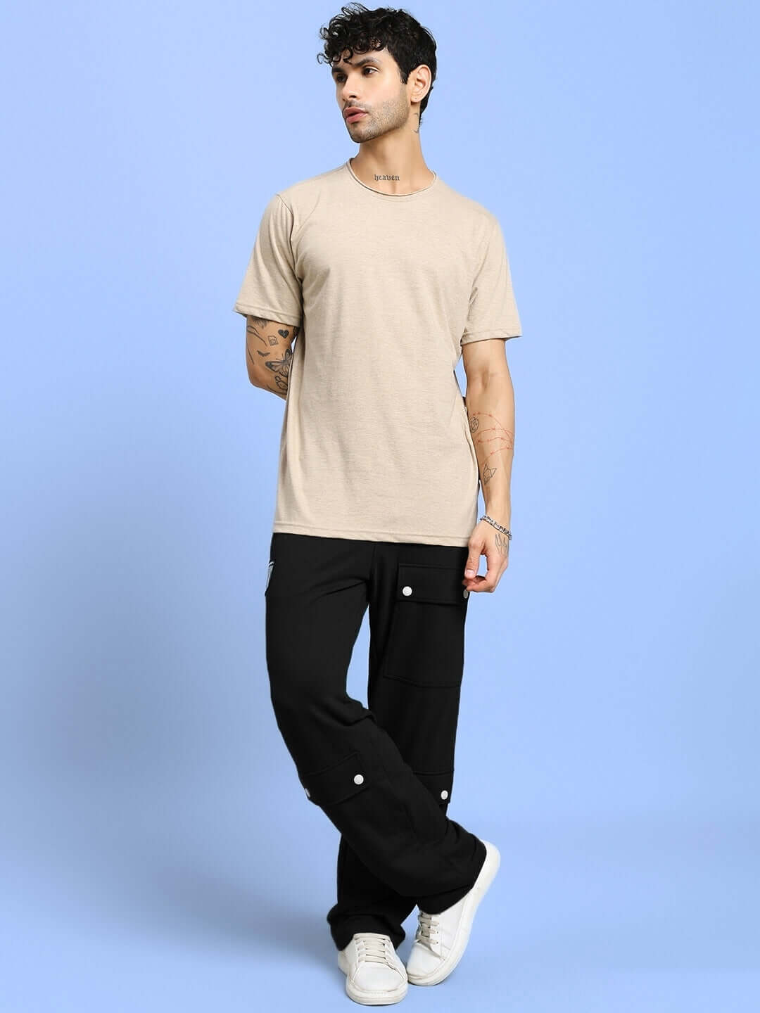 Person wearing AWESOME FLAP POCKET BAGGY JOGGER BLACK in a casual style against a blue background.