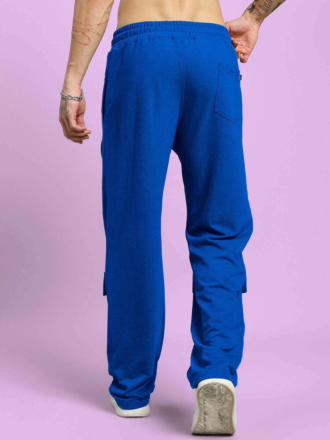 Back view of man wearing AWESOME FLAP POCKET BAGGY JOGGER BLUE showcasing bold blue color and utility-inspired design.