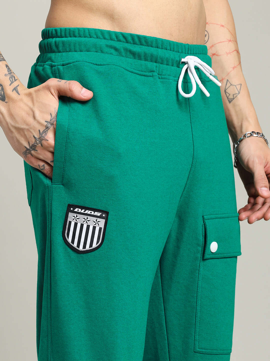 Model wearing AWESOME FLAP POCKET BAGGY JOGGER GREEN showcasing street-style fashion with functional design and relaxed fit.