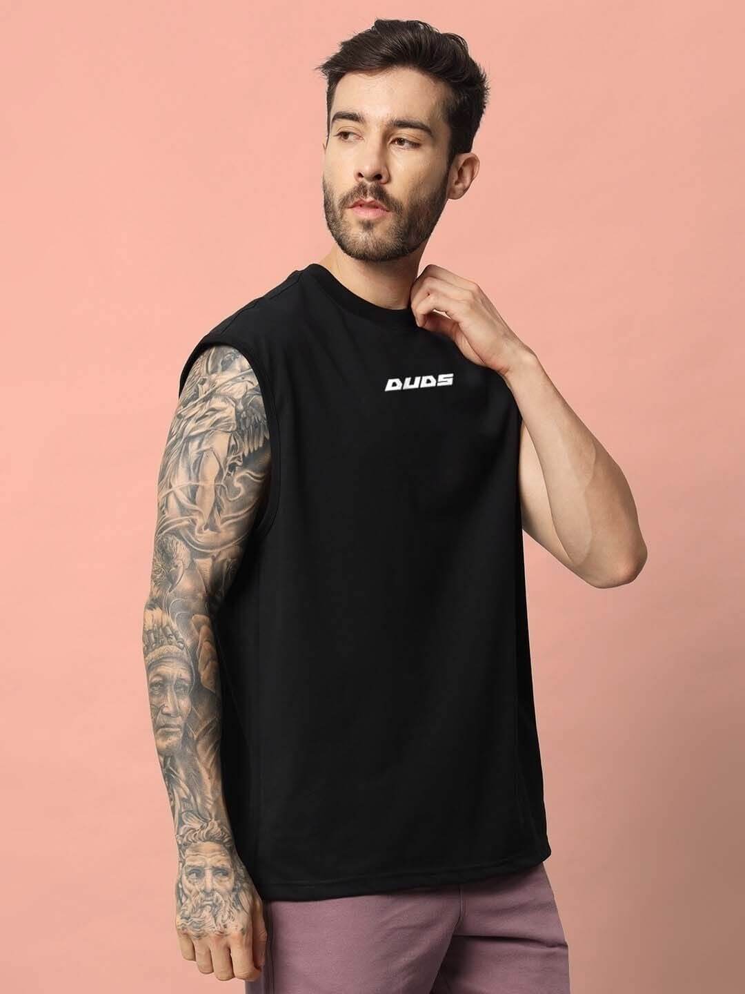 Man wearing a black Backbone Gym T-Shirt by DUDS, showcasing customizable fit. Ideal for workouts with premium handmade quality.