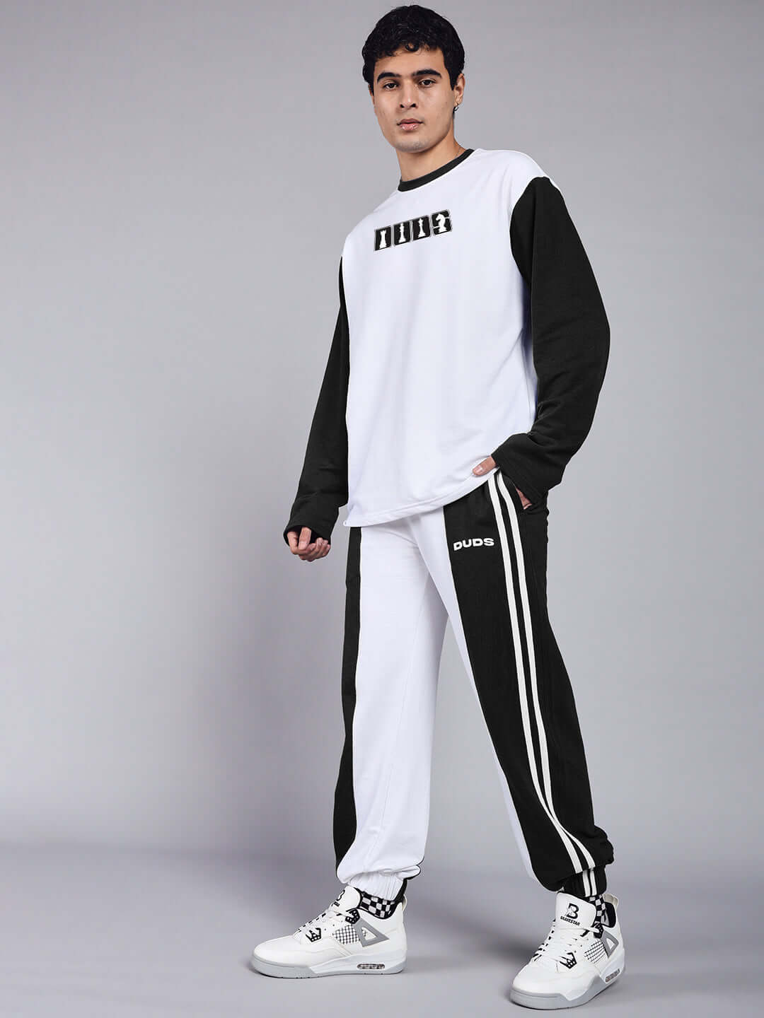 Model wearing BALMY Relaxed Fit Jogger in White-Black by DUDS, showcasing comfortable casual wear made by experienced tailors.