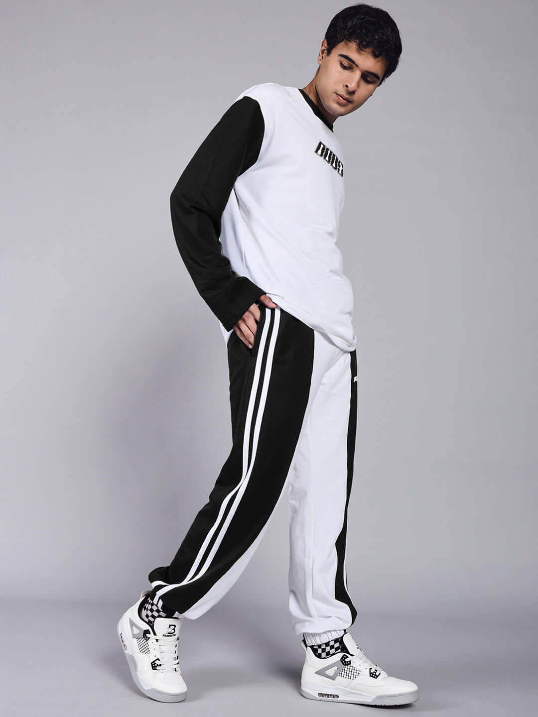 Model wearing Balmy Relaxed Fit Joggers in white-black, showcasing custom fit option by DUDS, suitable for casual style.