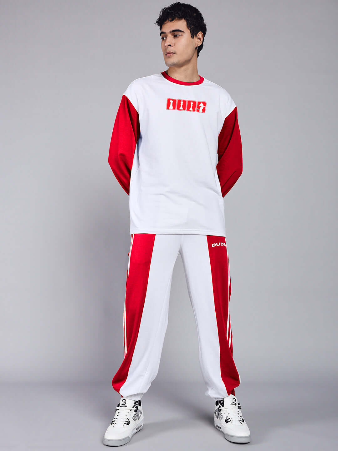 Model wearing Balmy Relaxed Fit Jogger in White and Red, showcasing sporty casual wear by DUDS.