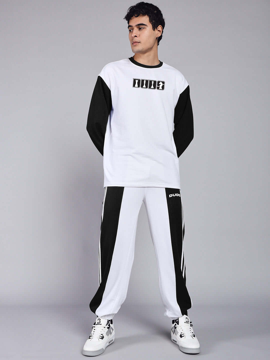 Model wearing Balmy Relaxed Fit Jogger in white and black by DUDS, showcasing a stylish and comfortable design.