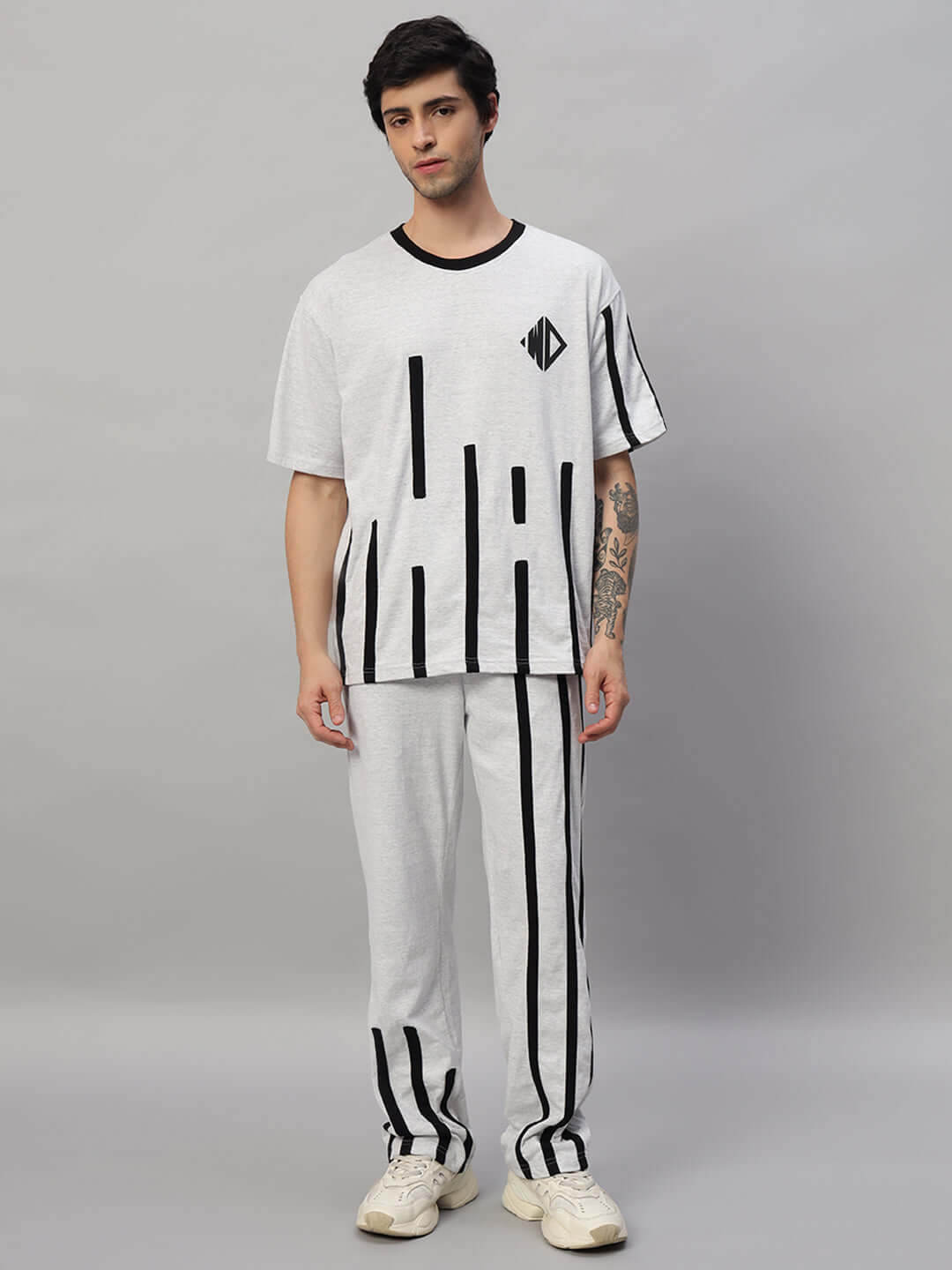 Model wearing a Bastille Oversized Co-ord Set in Melange Grey with black stripes, highlighting comfort and style for casual outings.