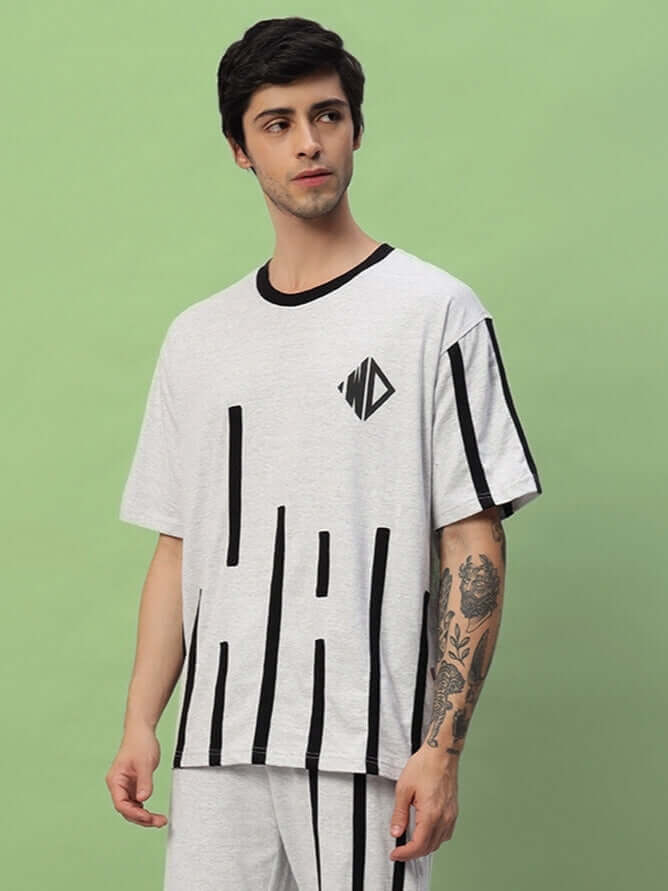 Model wearing BASTILLE OVERSIZED T-SHIRT MELANGE GREY showcasing relaxed fit and modern design.