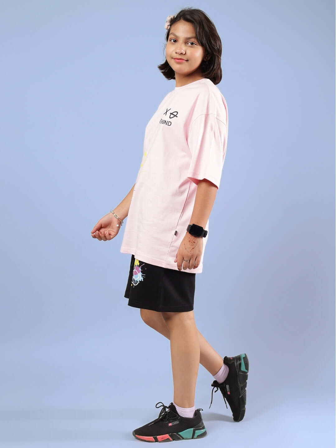 Child wearing BE KIND CO-ORD FOR BOYS GIRLS PINK-BLACK outfit with pink top and black shorts, suitable for all occasions.