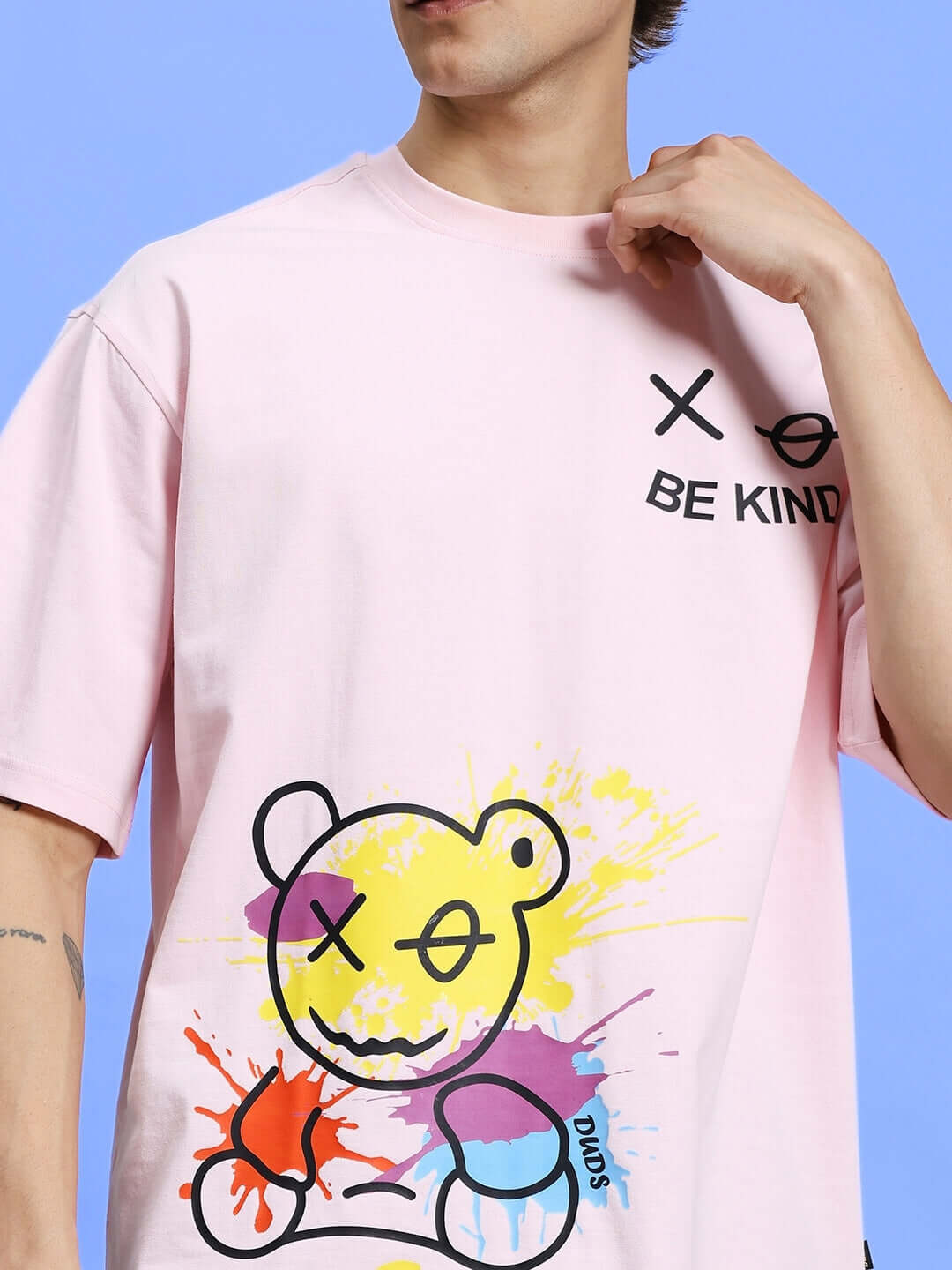 Model wearing BE KIND SUMMER CO-ORD SET PINK-BLACK with graphic t-shirt featuring colorful bear illustration.
