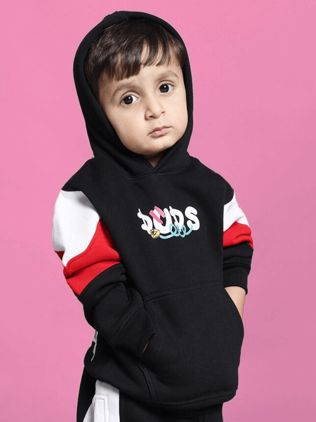 Child wearing black beanie hoodie from DUDS with colorful logo and red stripes.