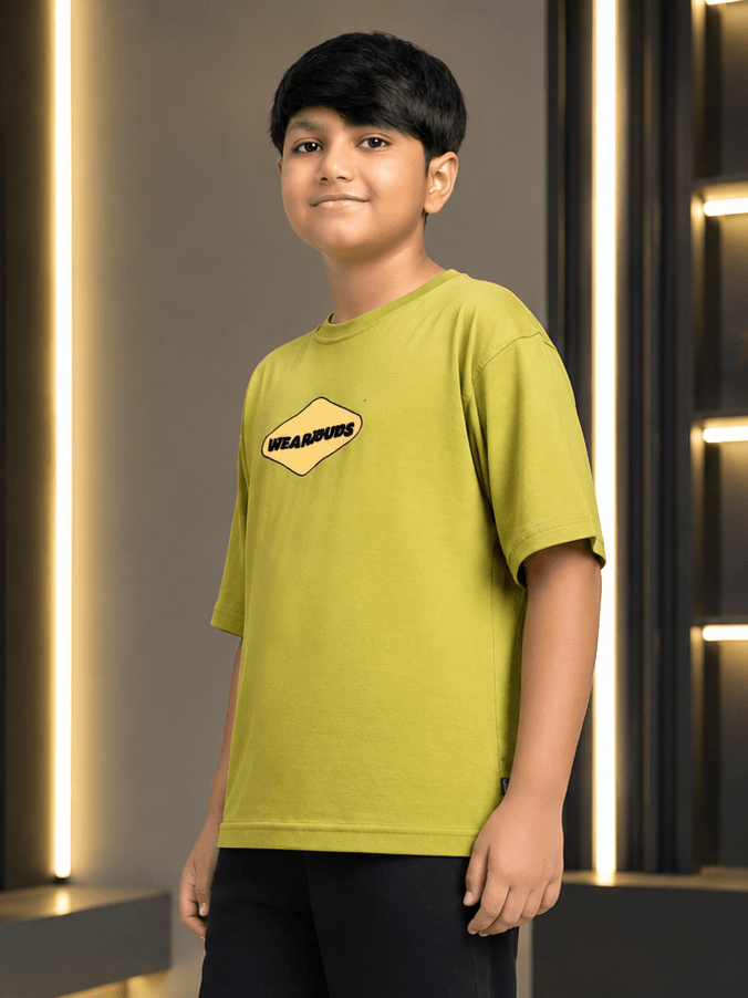 BEAR ON BOARD T-SHIRT FOR BOYS GIRLS OLIVE GREEN worn by a boy, showcasing its trendy design and comfortable fit.