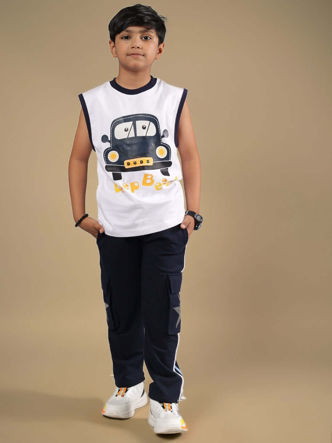 Child modeling the BEEP BEEP CO-ORD FOR BOYS & GIRLS WHITE NAVY outfit, featuring a fun car print and stylish contrast details.