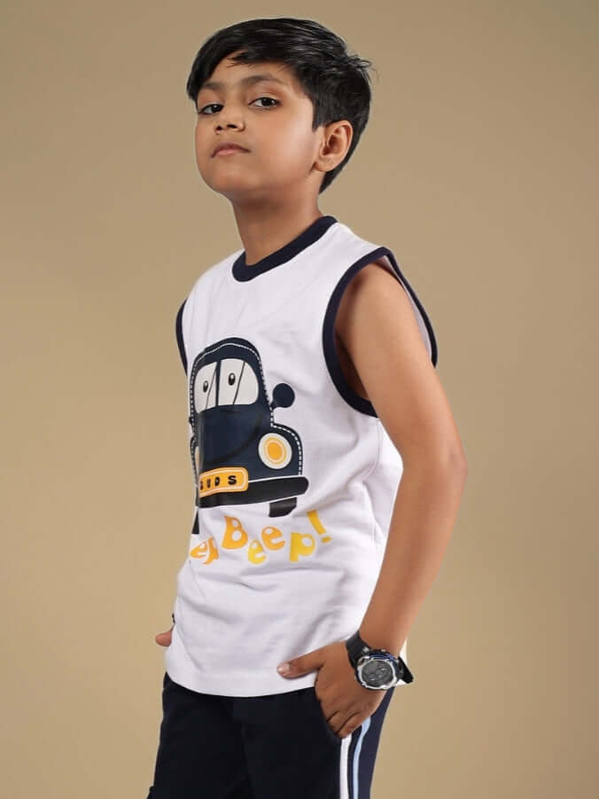Boy wearing BEEP BEEP T-SHIRT FOR BOYS & GIRLS WHITE with cartoon car print, posing confidently.