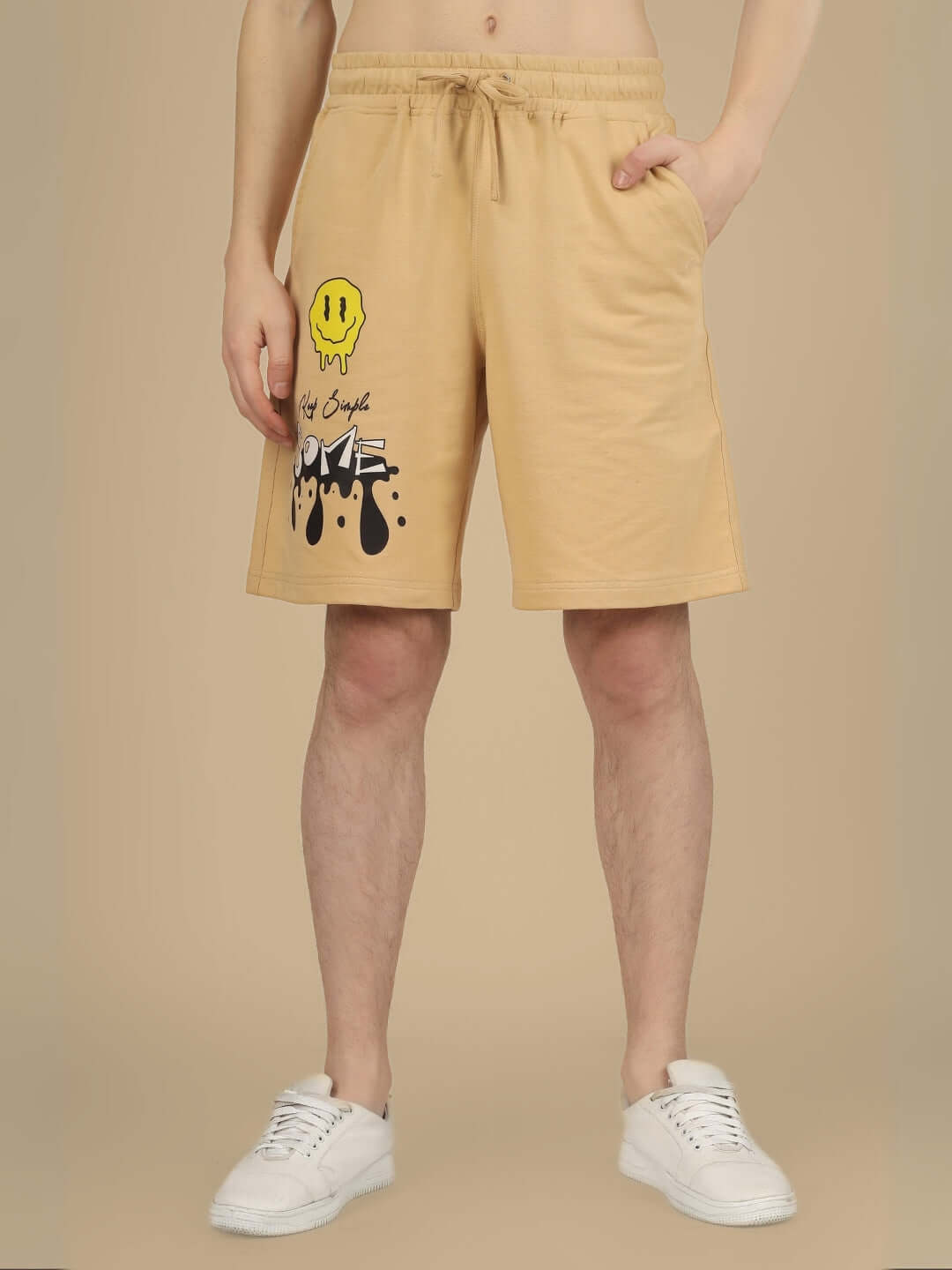 Beige regular fit shorts with smiley face print, customizable size option available, displayed on a model, perfect for casual wear.