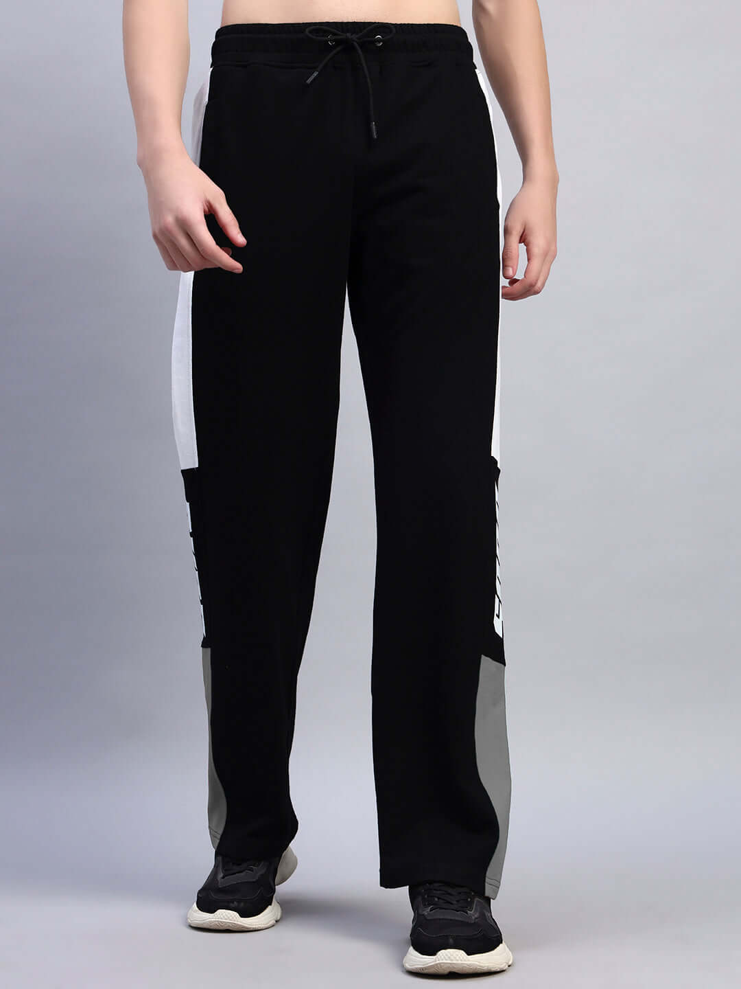 BELGIANS RELAXED-FIT JOGGERS BLACK GREY displayed by model showcasing dual-tone design and elastic waistband.