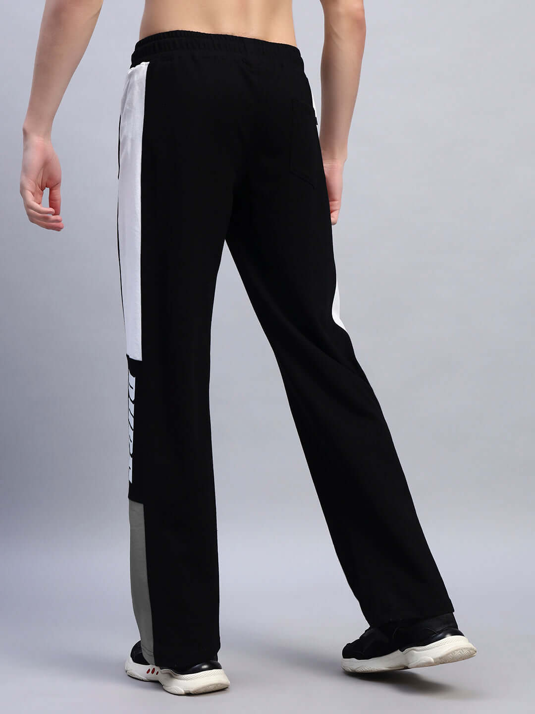 Rear view of BELGIANS RELAXED-FIT JOGGERS BLACK GREY on male model showcasing dual-tone design and fit.