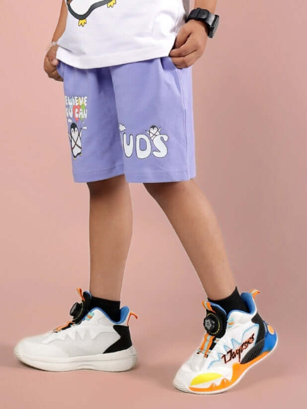 Child wearing BELIEVE SHORTS FOR BOYS & GIRLS LAVENDER with sneakers.