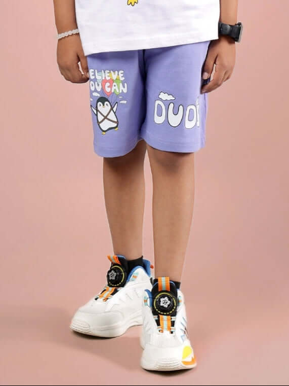 Child wearing BELIEVE SHORTS FOR BOYS & GIRLS LAVENDER with sneakers, showcasing lavender color and doodle prints.