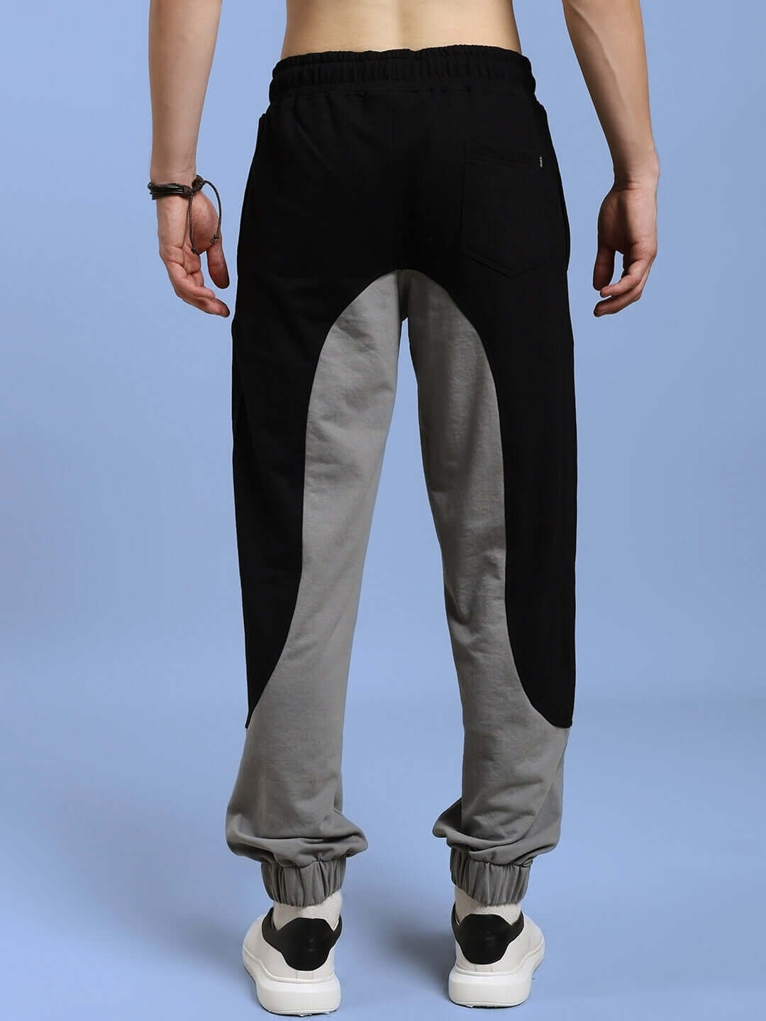 Rear view of person wearing BERLIN RELAXED FIT JOGGERS BLACK GREY with sleek black-grey color combination in soft-touch fabric.