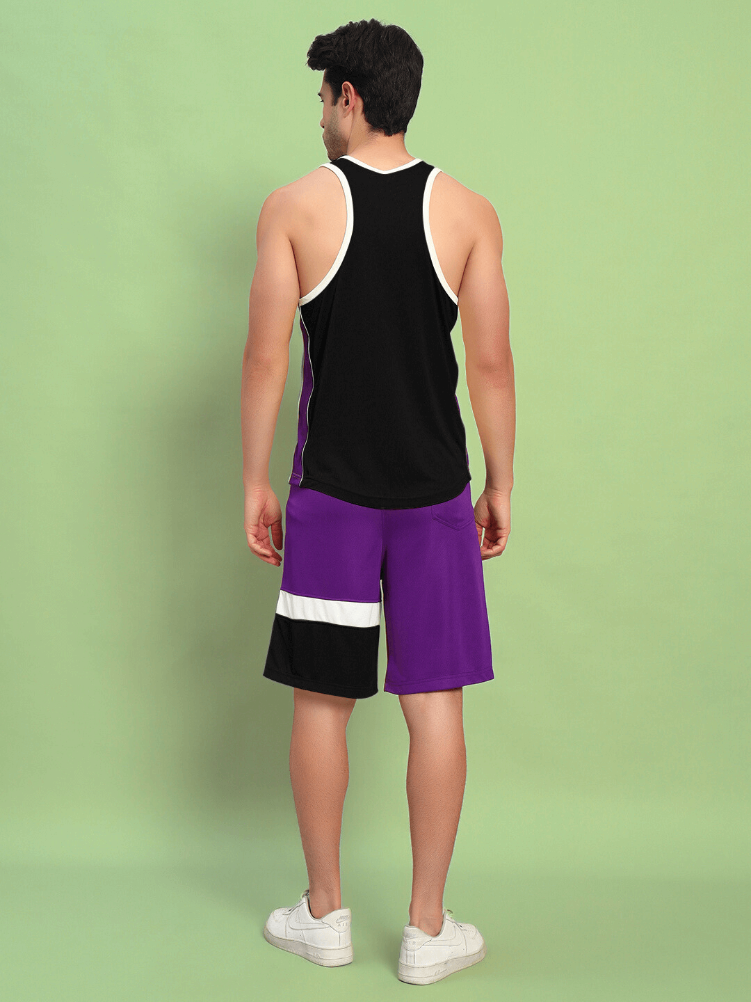 Rear view of BET ON YOURSELF GYM CO-ORD SET BLACK PURPLE in sports polyester fabric, worn by a model, ideal for gym workouts.