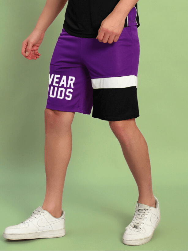 BET ON YOURSELF REGULAR FIT SHORTS PURPLE BLACK with white stripe, worn with white sneakers.