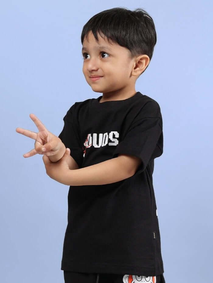 Child wearing BINGO T-SHIRT FOR BOYS GIRLS BLACK, featuring a playful design on a soft cotton tee.